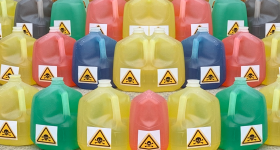 colorful gallon jugs with poison stickers